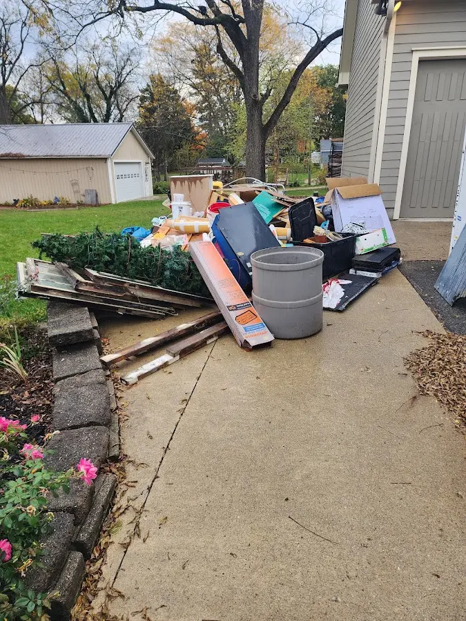 Dumpster being loaded with debris for 12 Yard Dumpster Rental in Wellington